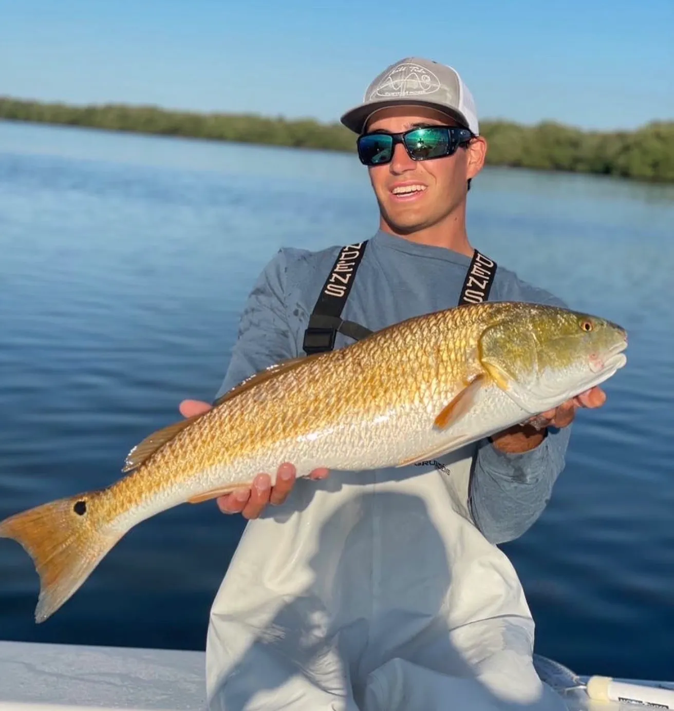 Captain Evan Soudijn holding a redfish