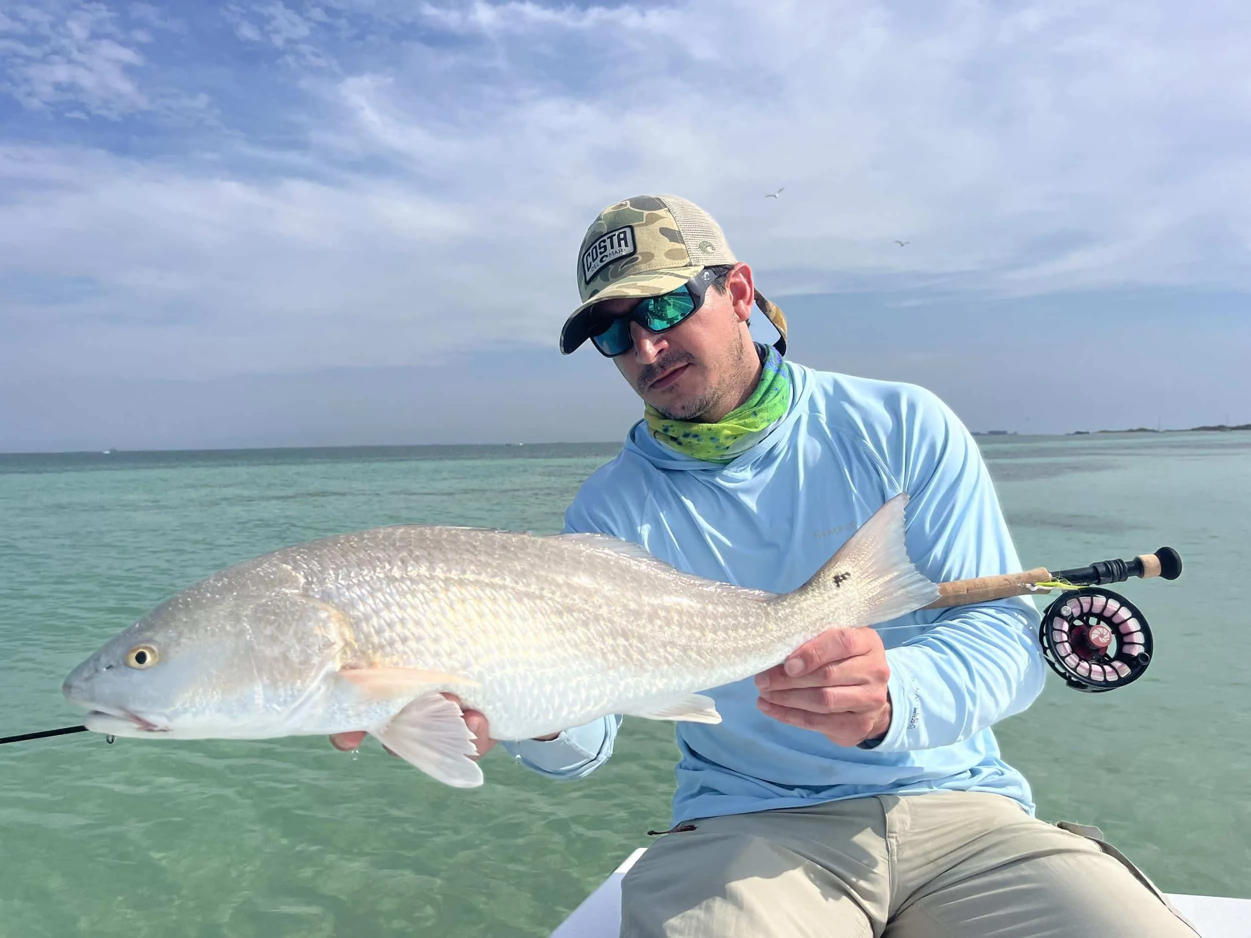 Angler fly fishing aboard the boat
